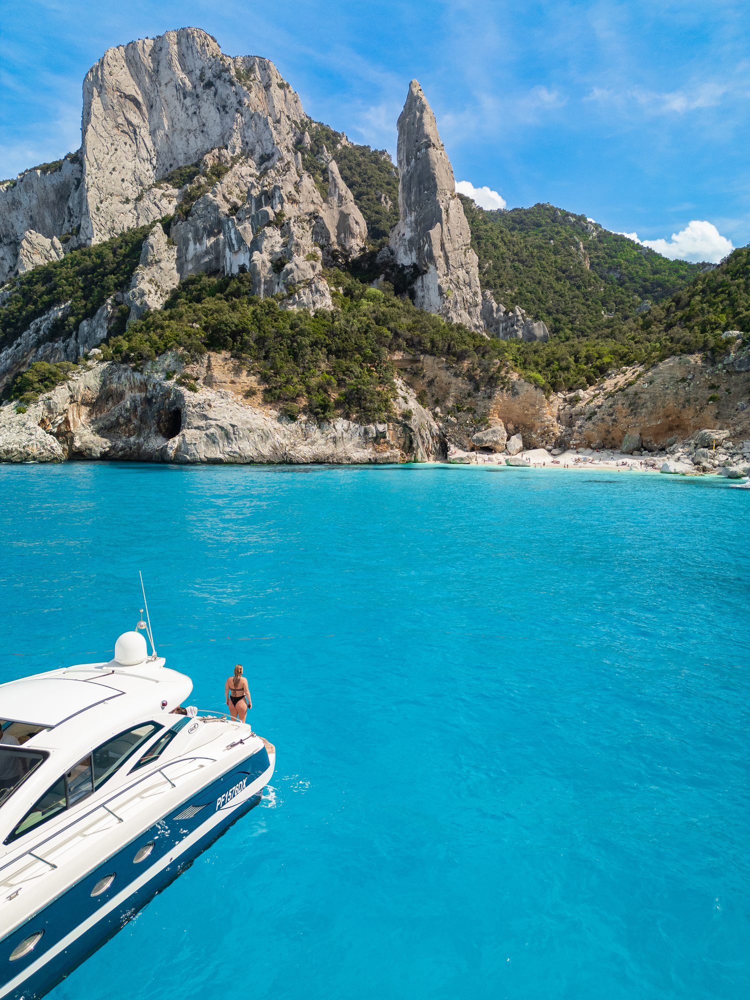 A yacht anchored near a tropical coastline