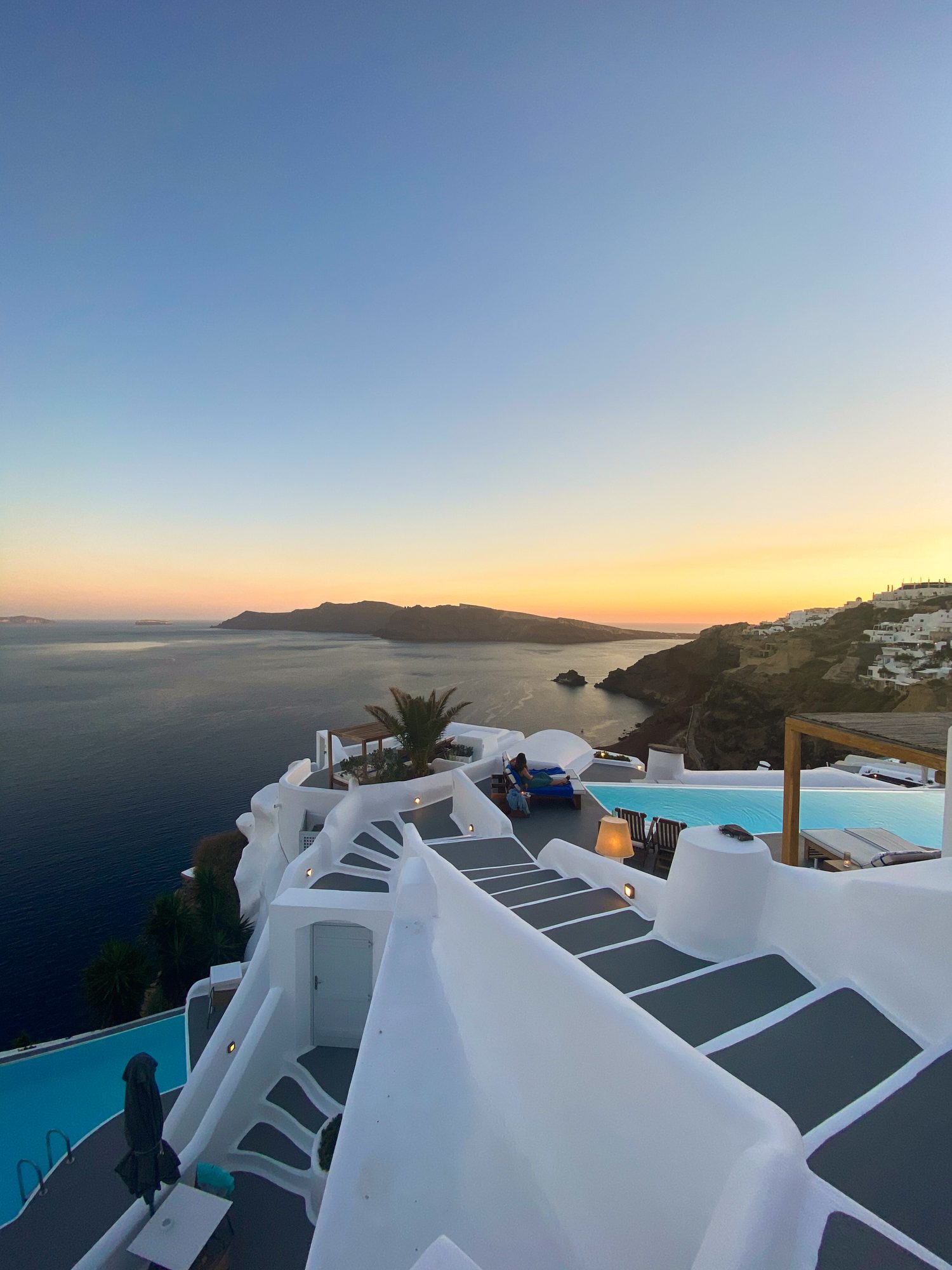 A whitewashed building overlooking the sunset in Greece
