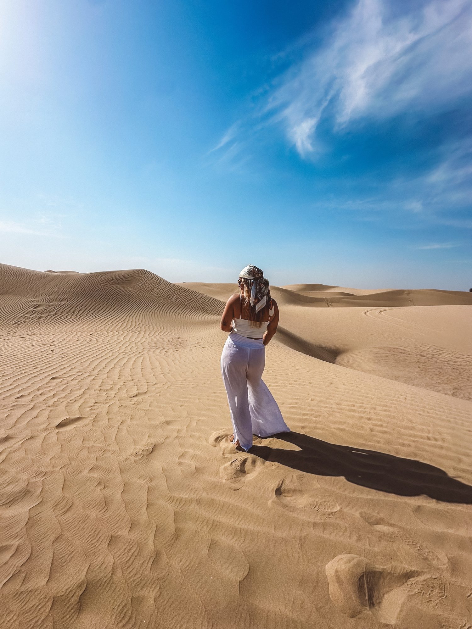 A traveler pausing among the dunes of the Moroccan desert